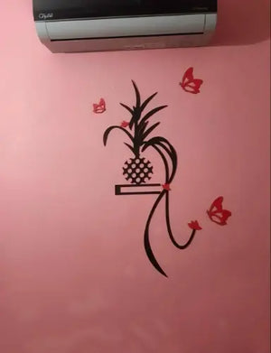 Decorative wall sticker with a plant design on a pink wall.