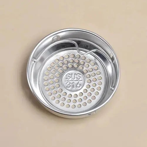 Stainless steel strainer with 'SUS 316' marking on a beige background