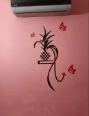 Decorative wall sticker with a plant design on a pink wall.