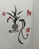 Decorative wall sticker with a pineapple and butterflies on a white wall.