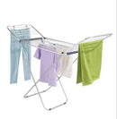 Metal clothes drying rack with colorful towels on a white background