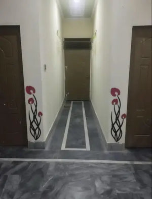 Corridor with floral designs on the walls and floor.