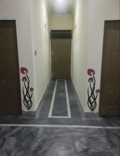 Corridor with floral designs on the walls and floor.
