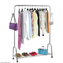 Clothing rack with clothes, shoes, and bags on a white background