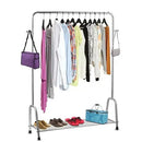 Clothing rack with clothes, shoes, and bags on a white background