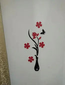 Decorative wall sticker with red flowers and a black vase on a white background