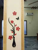 Decorative wall sticker with flowers and a vase on a wall.