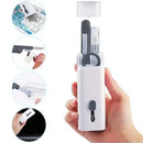 Hand holding a white cleaning tool set with various attachments on a white background