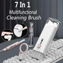 7-in-1 multifunctional cleaning brush with various uses on a keyboard.