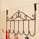Decorative wall-mounted hook rack with multiple hooks on a wooden background