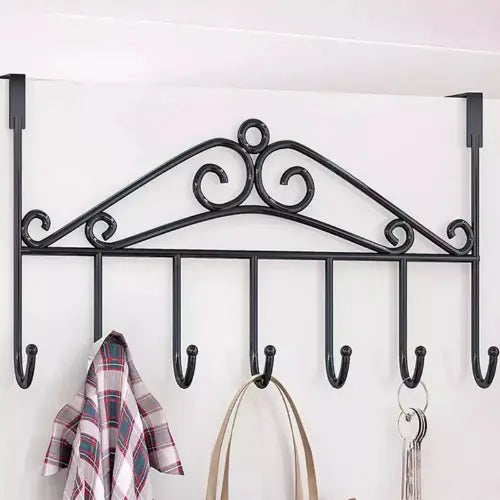 Decorative wall hook with multiple hooks holding a plaid shirt, bag, and keys on a white background.