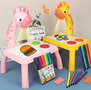 Children's toy table and chairs with coloring books and markers on a blue surface.