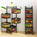 Two black metal rolling shelves with mesh baskets filled with fruits and vegetables in a kitchen setting.