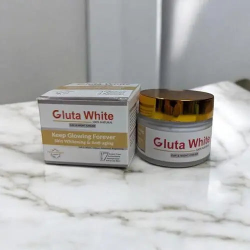 Gluta White skin whitening cream jar and box on a marble surface
