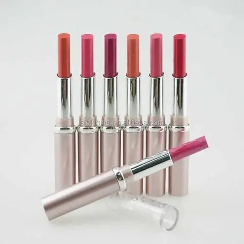 Set of lipsticks with pink and red shades on a white background